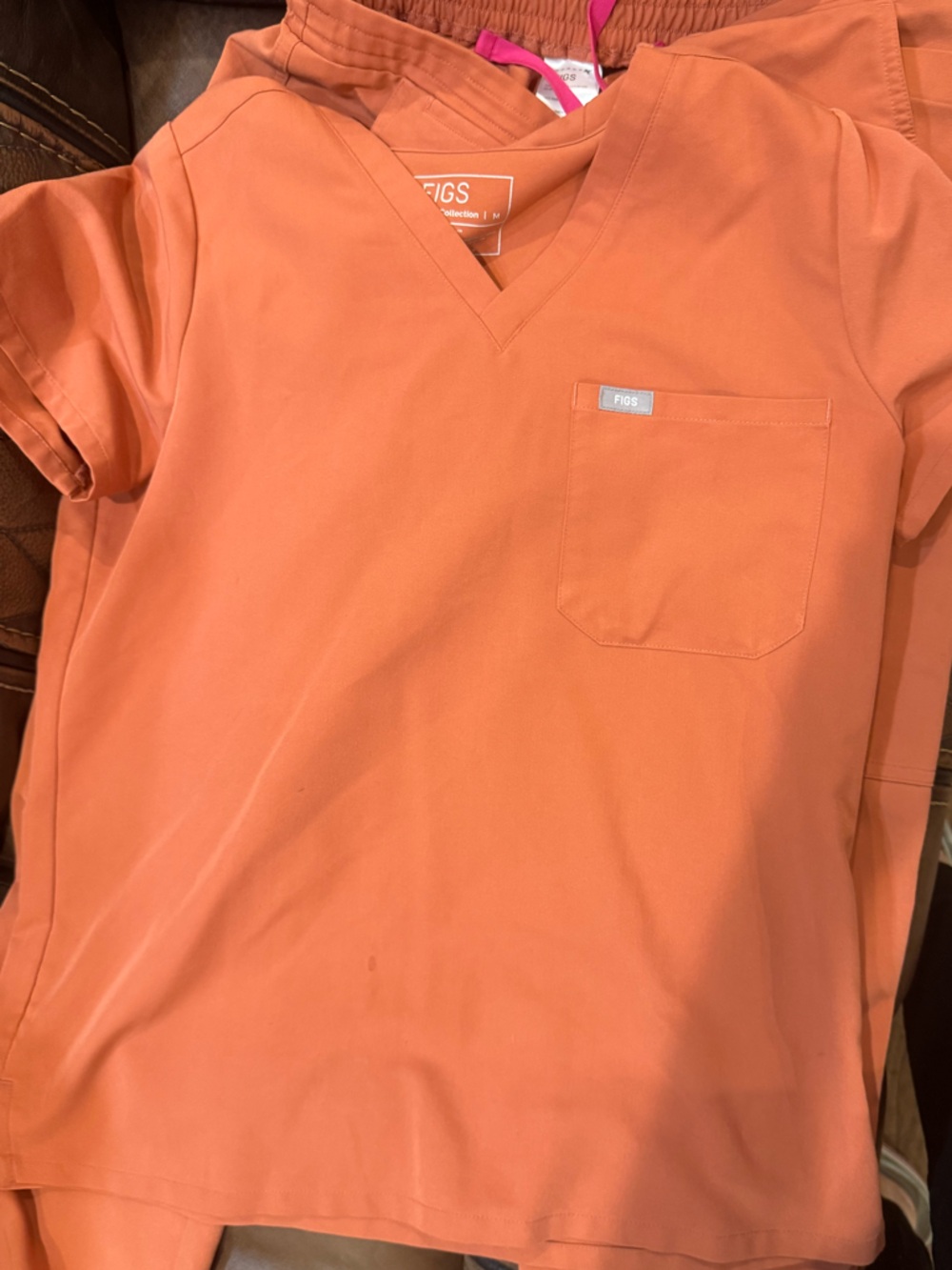 FIGS medium scrub set in orange.